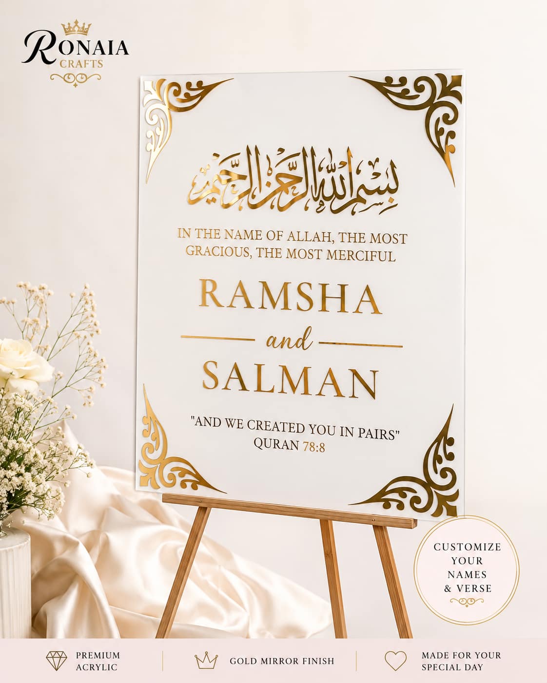Elegant personalized wedding welcome sign on a wooden easel beside a front door decorated with blush florals and draped fabric